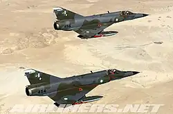 Two Pakistan Air Force Dassault Mirage 5PA2 inflight, carrying drop tanks and AIM-9 Sidewinder air-to-air missiles