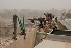 A Special Forces operator in Syria alongside a SF Multi-Purpose Canine provides security for a nearby mortar position during the Deir ez-Zor campaign, October 11, 2018.