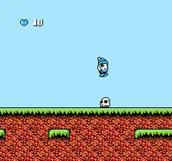 Screenshot from the game's first area: Bop-Louie (the player) is shown, jumping on a Teketeke, one of the main enemies in the game.