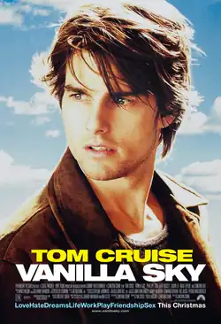 The profile of Tom Cruise as David Aames, Jr. atop a partly cloudy blue sky background.