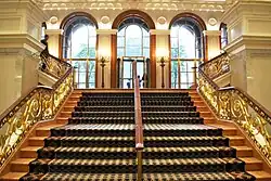 View of a stair in the Palace Hotel's lobby, formerly the center wing of the Villard Houses. The staircase leads up to a set of three arches that formed the entrances to 453&nbsp;and 455&nbsp;Madison Avenue.