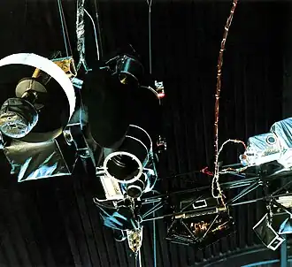 A view of some of Voyager's instruments from below. Left: the cameras, ultraviolet and infrared spectrometers (far left), plasma detector (black box lower right), particle and radiation detectors (far right). On the boom, center and right, are plasma, particle, and cosmic ray detectors.