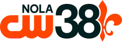 The CW logo in orange with the letters "N O L A" above it in a sans serif in black, right-aligned. Next to both on the right is a sans serif numeral 38. On the right, behind the 8, is half of a fleur-de-lis in orange.