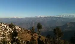 A view of the left half of the Gangotri Group in the Western Himalayas from Pauri, part of which is seen on the left. Pauri City as viewed from adjacent hill.