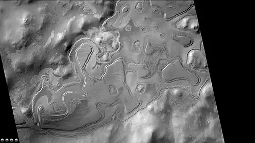 Layers just outside rim of western side of South crater in the form of "Swiss cheese," as seen by CTX camera. Note: this is an enlargement of a previous image of west side of South crater.