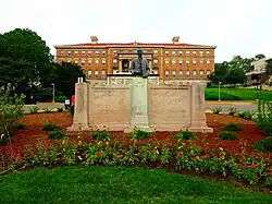 A statue of Hoard mounted on a relief depicting an agricultural scene
