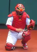 Yadier Molina using a PitchCom keypad on his knee