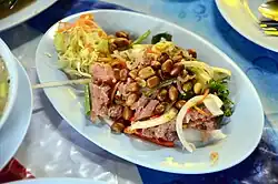 Yam naem, a salad with naem sausage made from raw pork fermented with glutinous rice