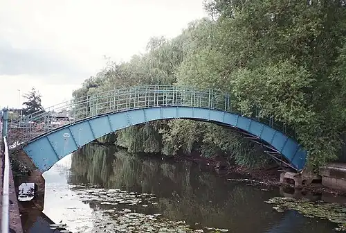 Pedestrian bridge from the west, looking downstream near DEFRA buildings, 53°57′37″N 1°04′22″W﻿ / ﻿53.960272; -1.072903